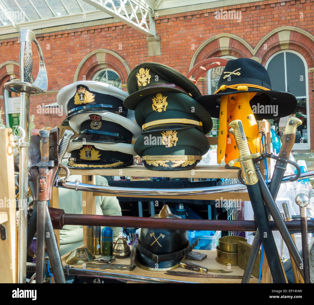 Military hats on market stall at Tynemouth weekend market in Tynemouth Metro station. Tynemouth, north east England. UK Stock Photo