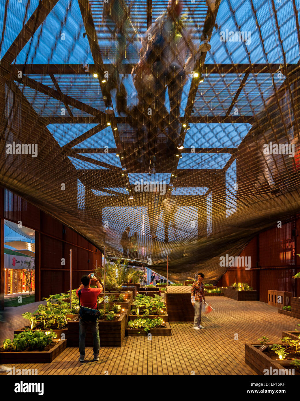 Ground floor with planters, ramp and net structure at night. Milan EXPO ...