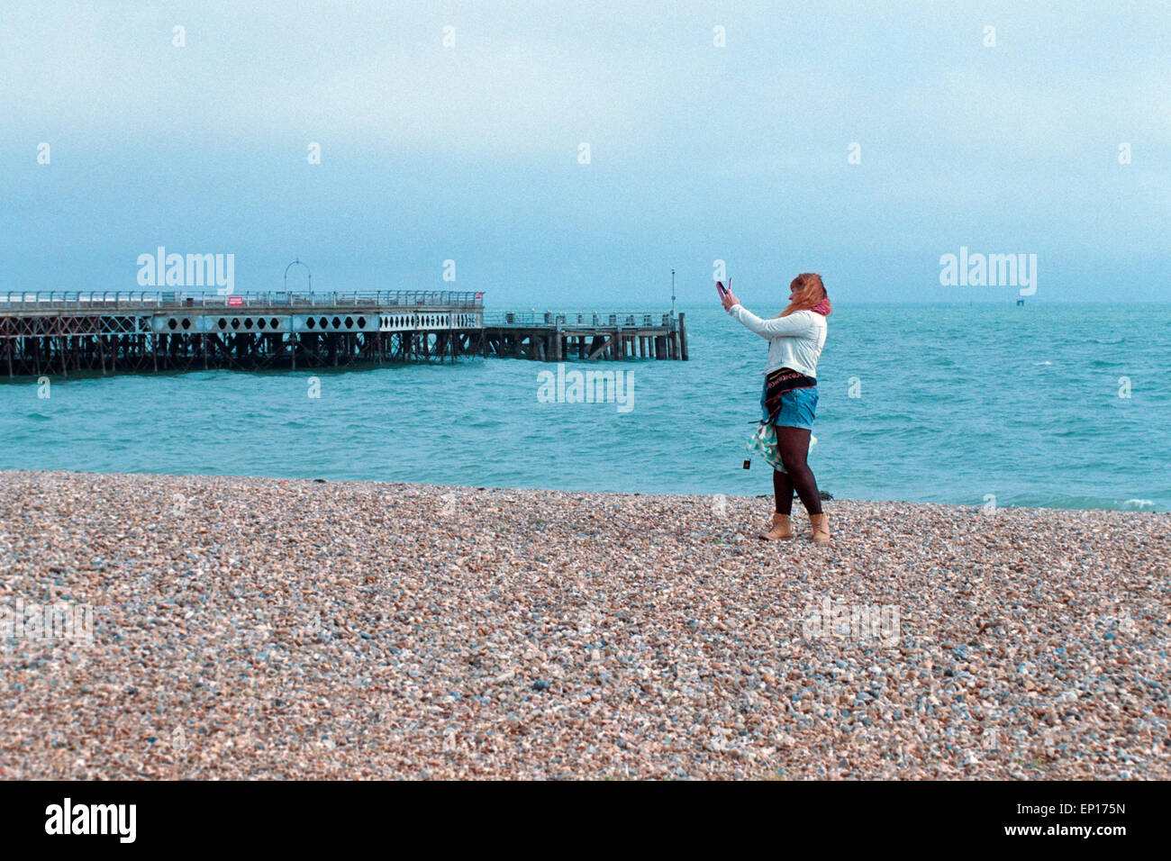 young woman taking a selfie with a tablet on southsea beach england uk Stock Photo