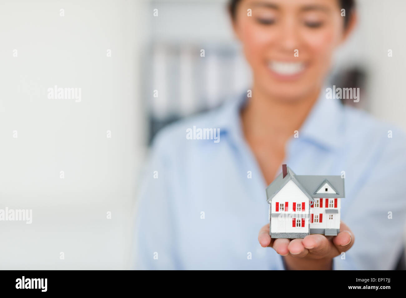 Miniature house held by a charming woman Stock Photo - Alamy