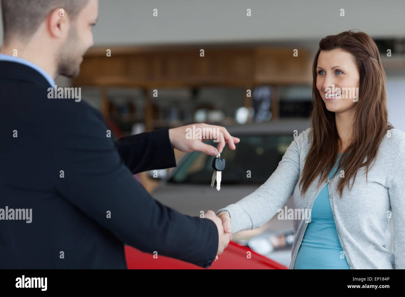 Car dealer giving keys shaking hi-res stock photography and images - Alamy