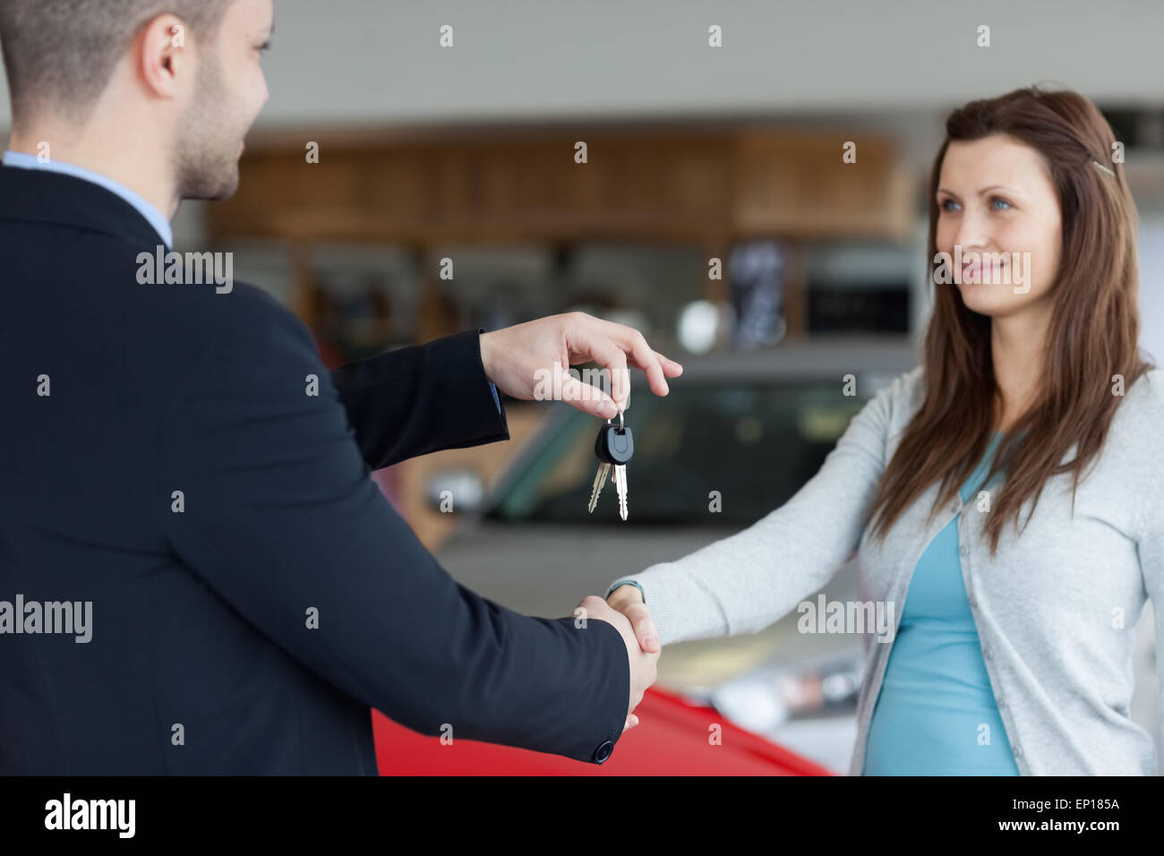 Car dealer giving keys shaking hi-res stock photography and images - Alamy
