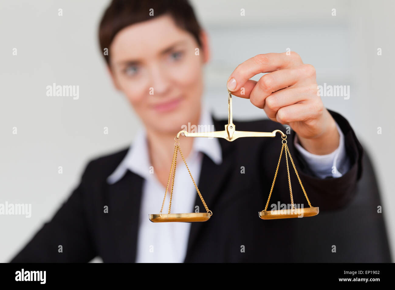 Serious businesswoman holding the justice scale Stock Photo