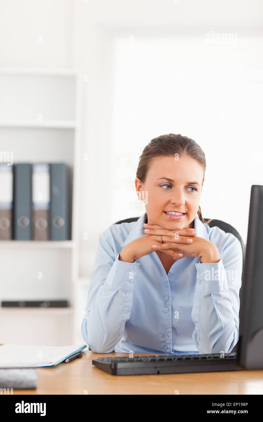 Office worker looking at her computer Stock Photo - Alamy