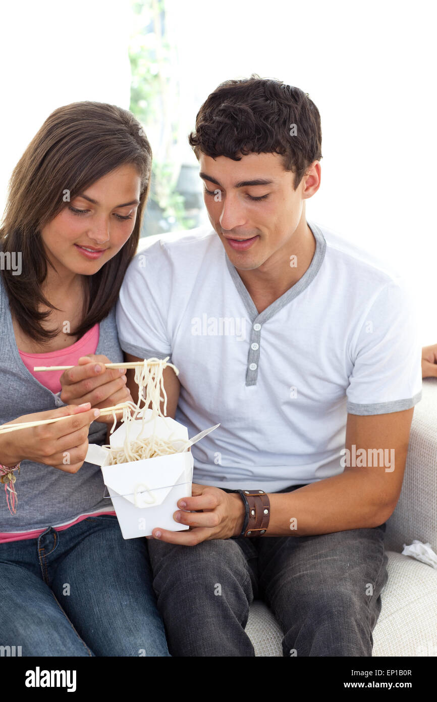 Couple of teenagers eating pasta Stock Photo