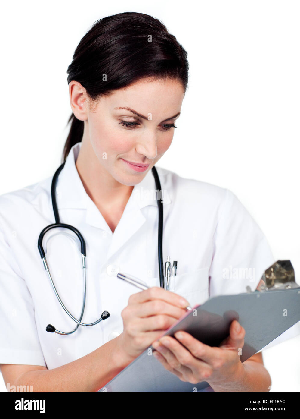 Confident female doctor writing on a clipboard Stock Photo - Alamy