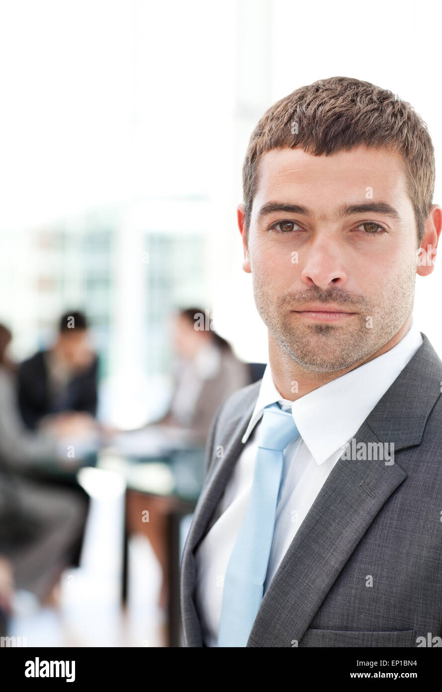 Charismatic businessman standing in the foreground Stock Photo