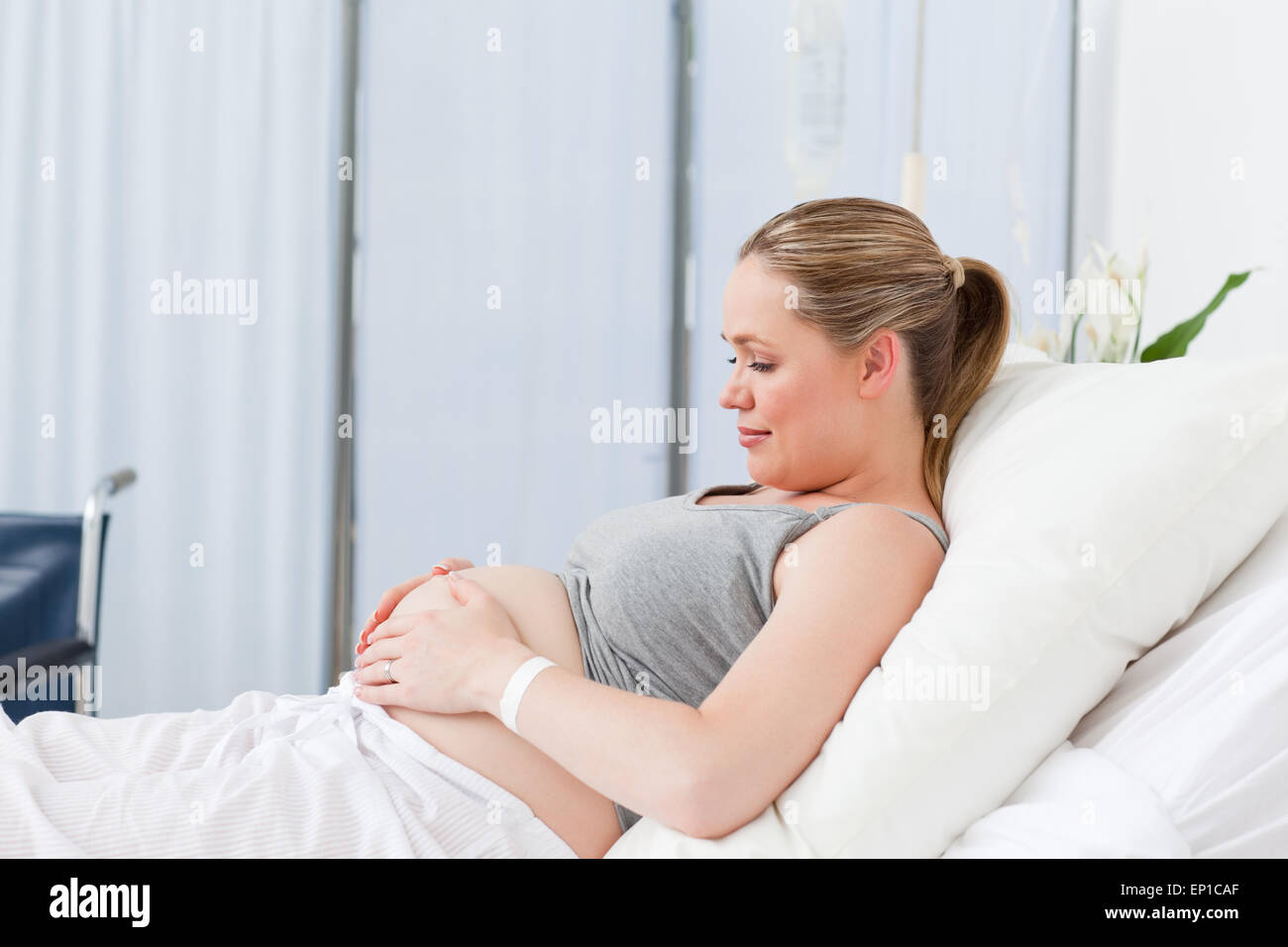 Pregnant young woman on a hospital bed Stock Photo Alamy