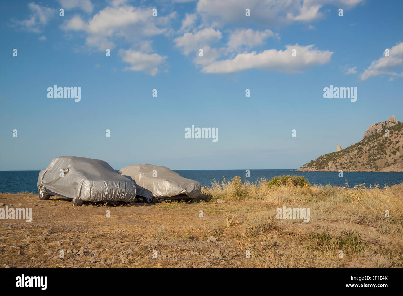 Car tourism - two vehicles parked on the sea shore and covered with tents Stock Photo