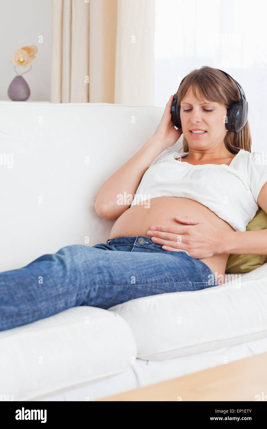 Portrait of a happy pregnant woman listening to music Stock Photo - Alamy