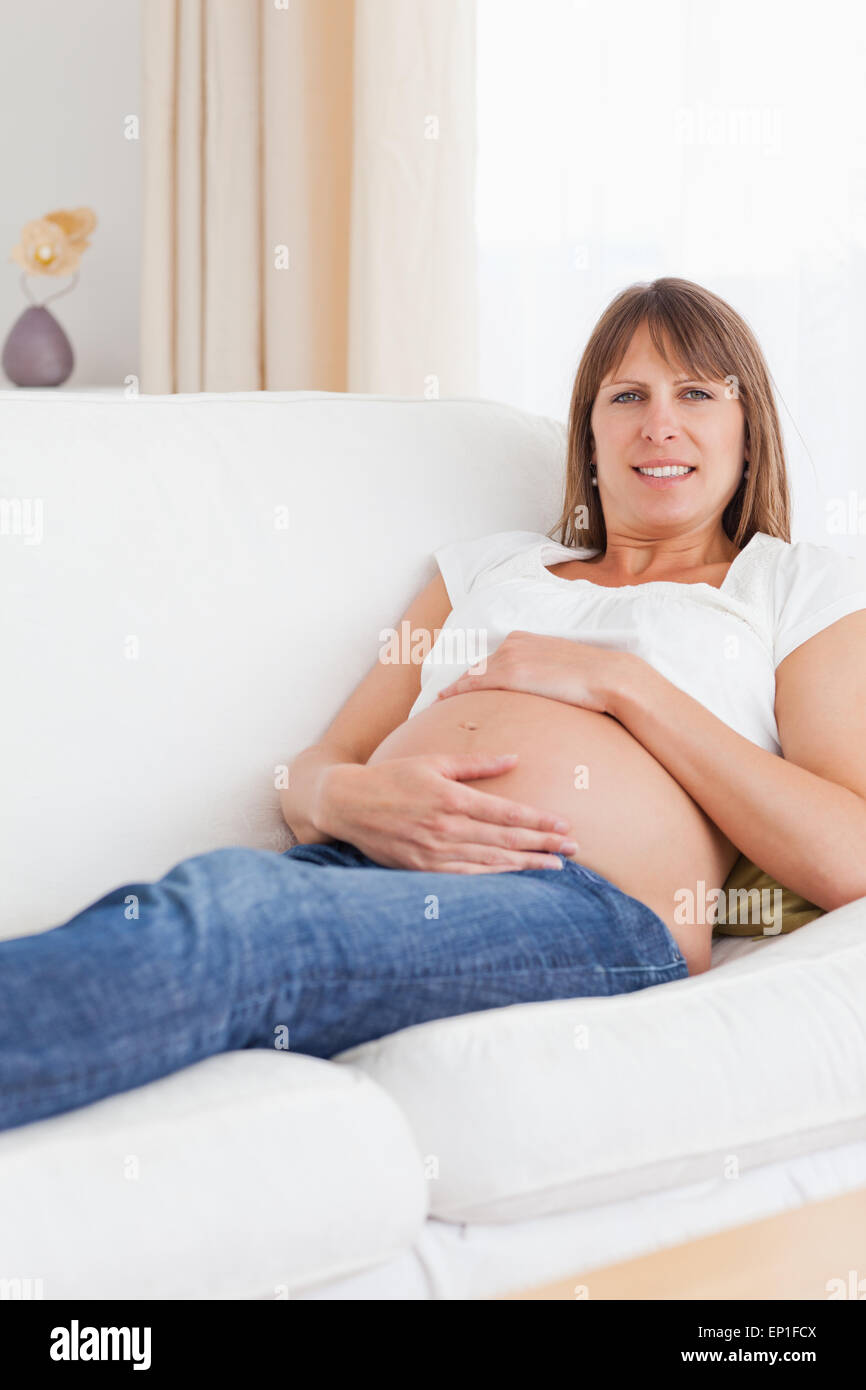 Portrait of a pregnant woman holding her belly Stock Photo - Alamy
