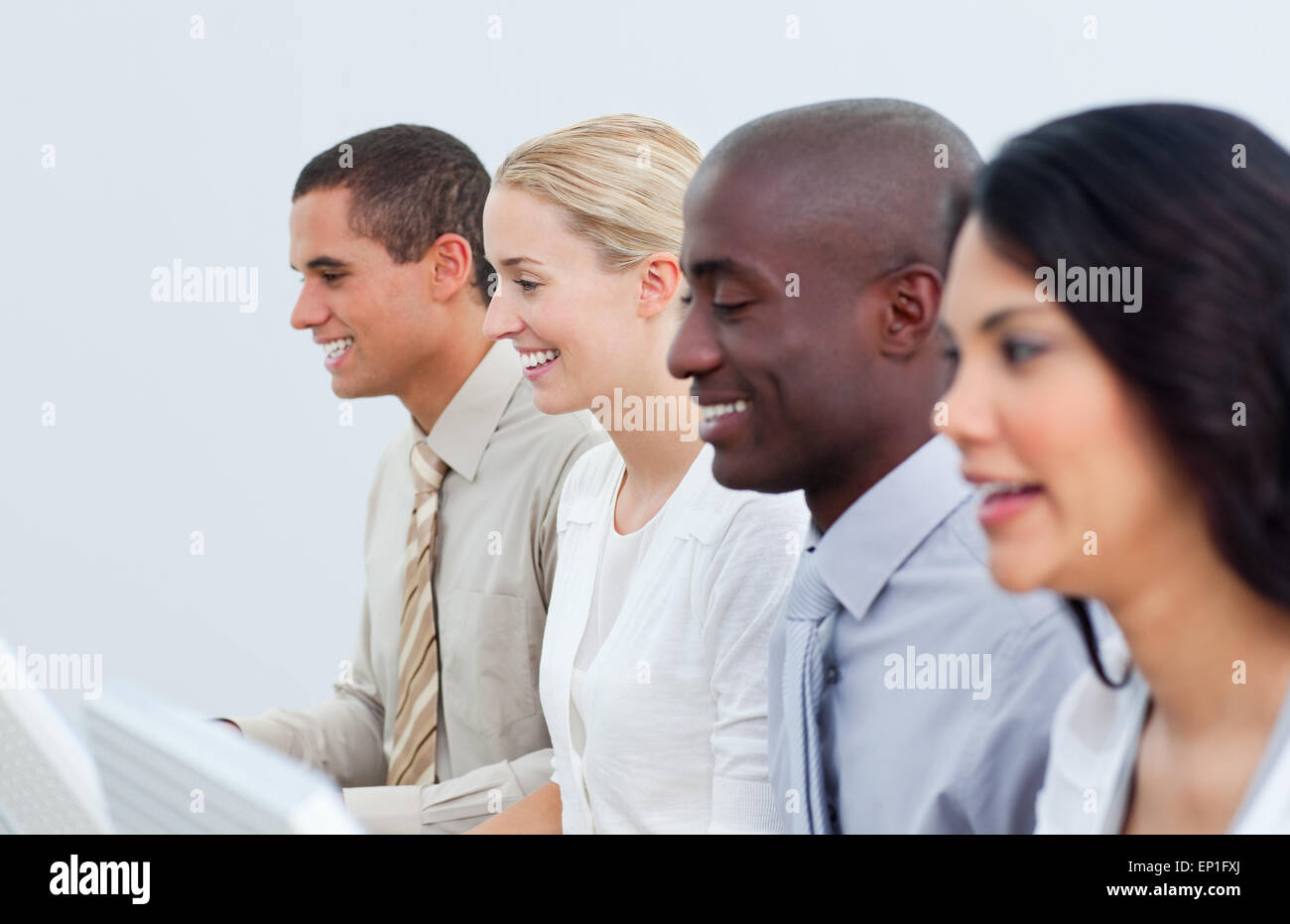 Multi-cultural business team working in the office Stock Photo - Alamy