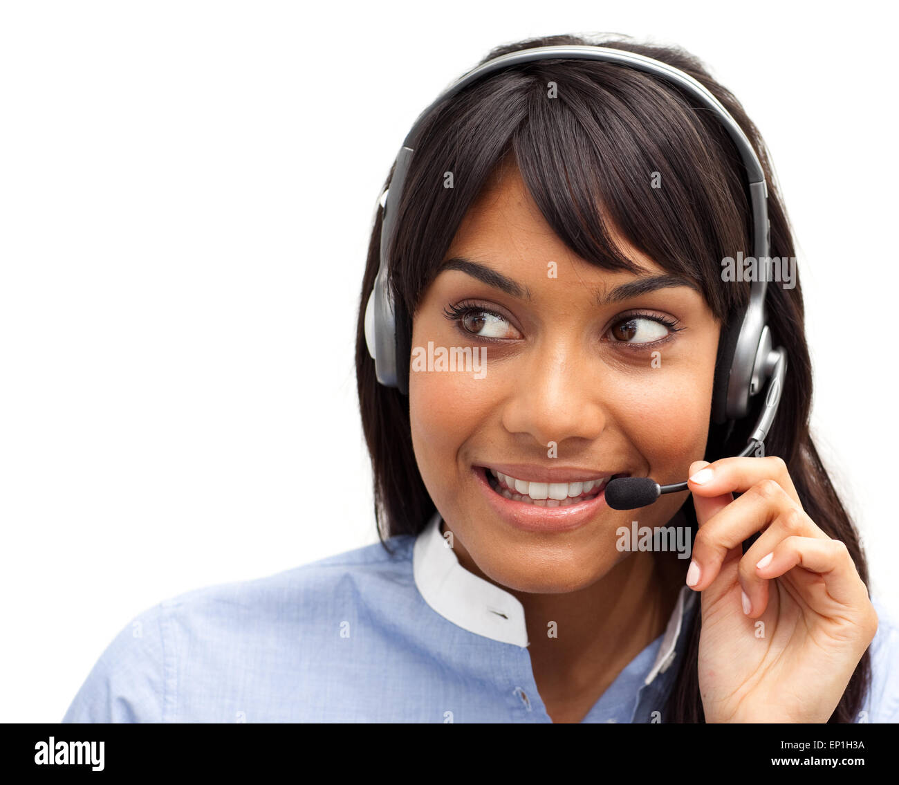 Attractive ethnic customer service representative using headset Stock
