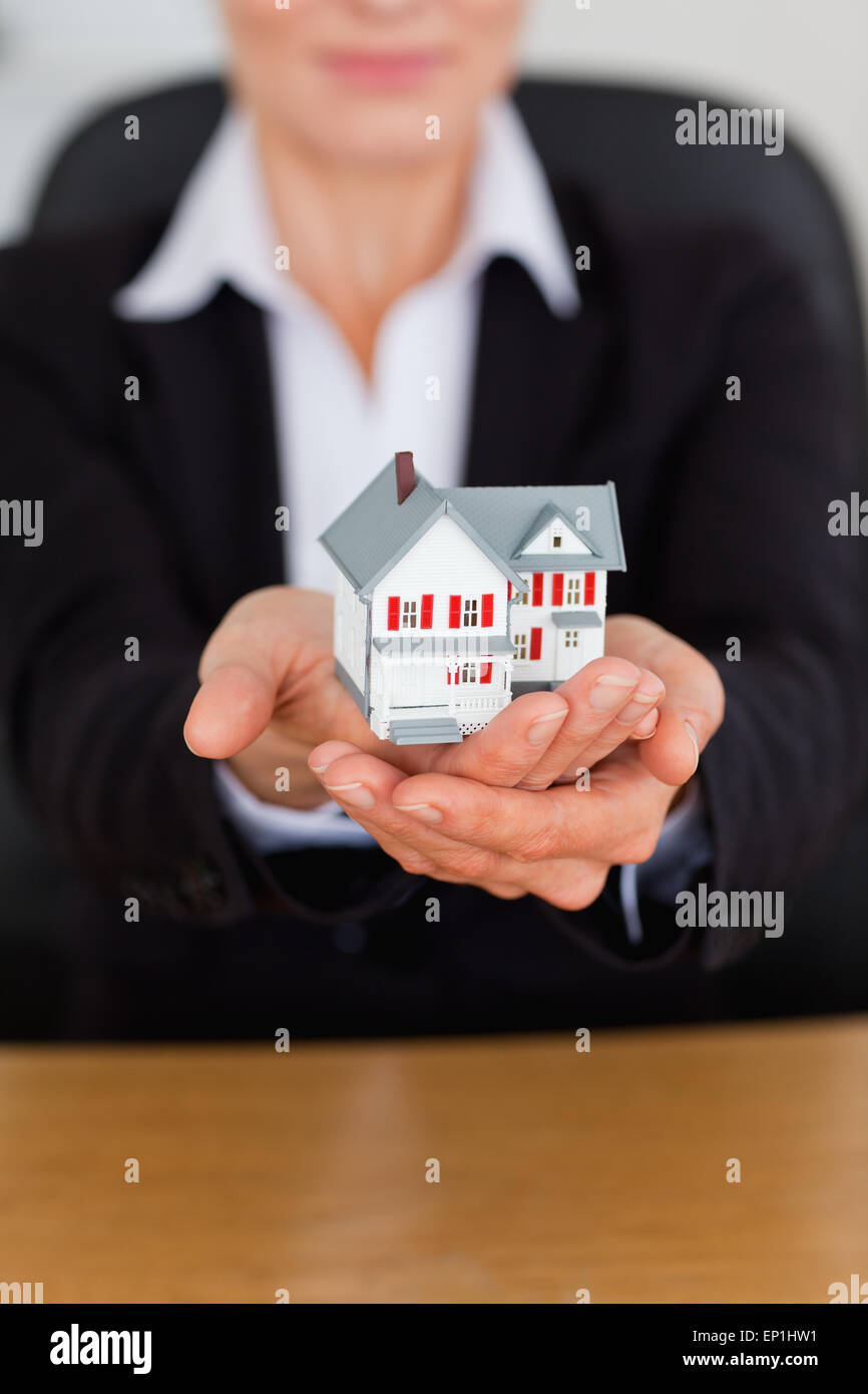 Portrait of feminine hands holding a miniature house Stock Photo - Alamy