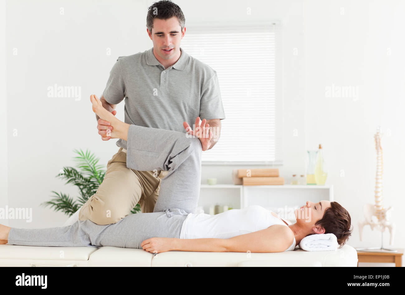 Chiropractor stretching a woman's leg Stock Photo