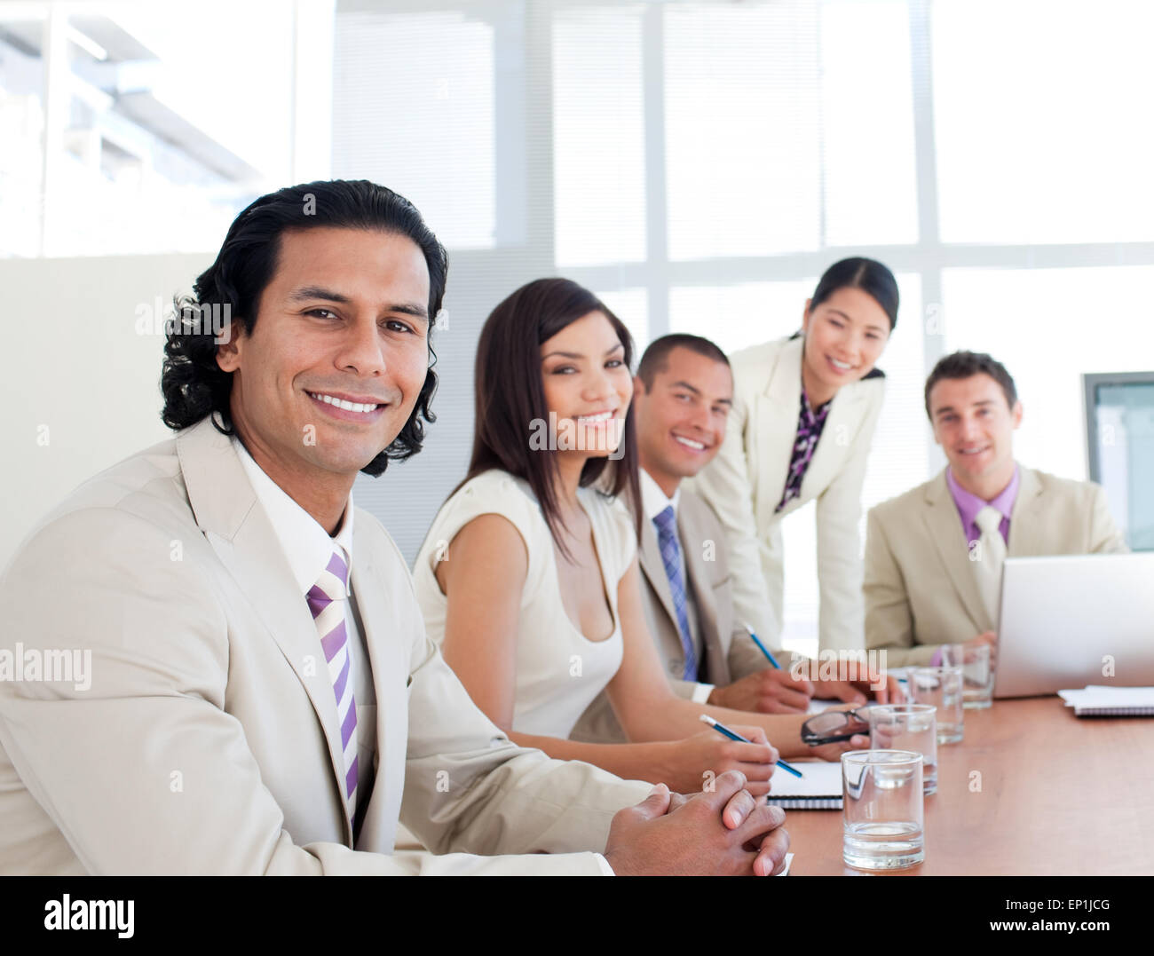 Portrait of a smiling business team in a meeting Stock Photo - Alamy