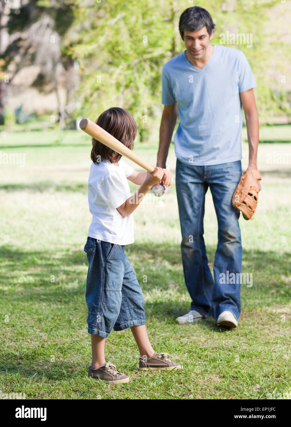 Cute little boy playing baseball with his father Stock Photo