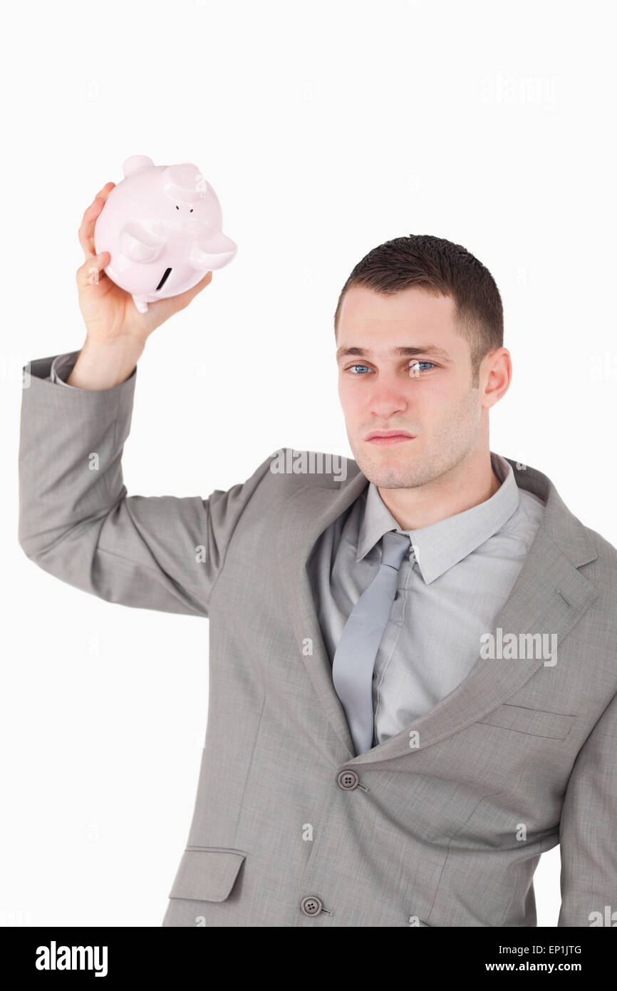 Portrait of a businessman shaking an empty piggy bank Stock Photo - Alamy