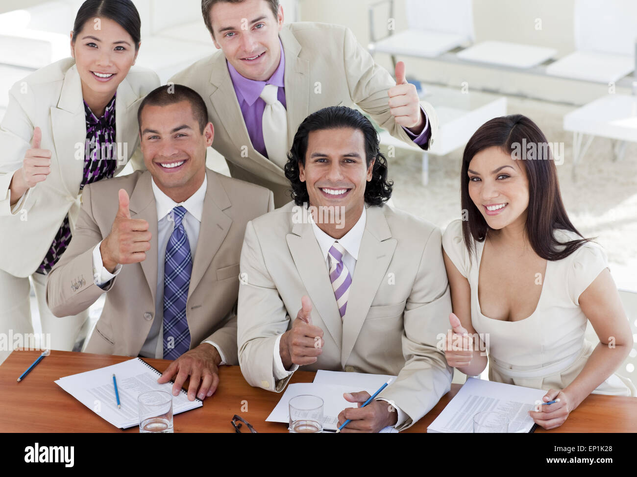 Successful business team with thumbs up Stock Photo - Alamy