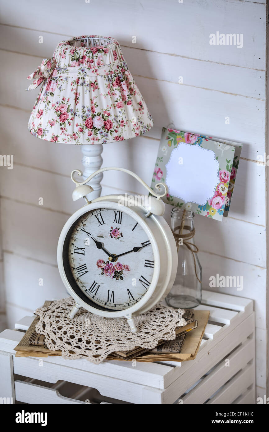 Bedside table with lamp and alarm clock Stock Photo