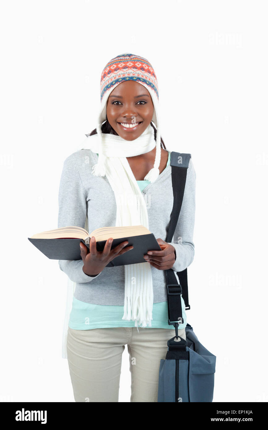 Smiling young student in winter clothing and book Stock Photo - Alamy