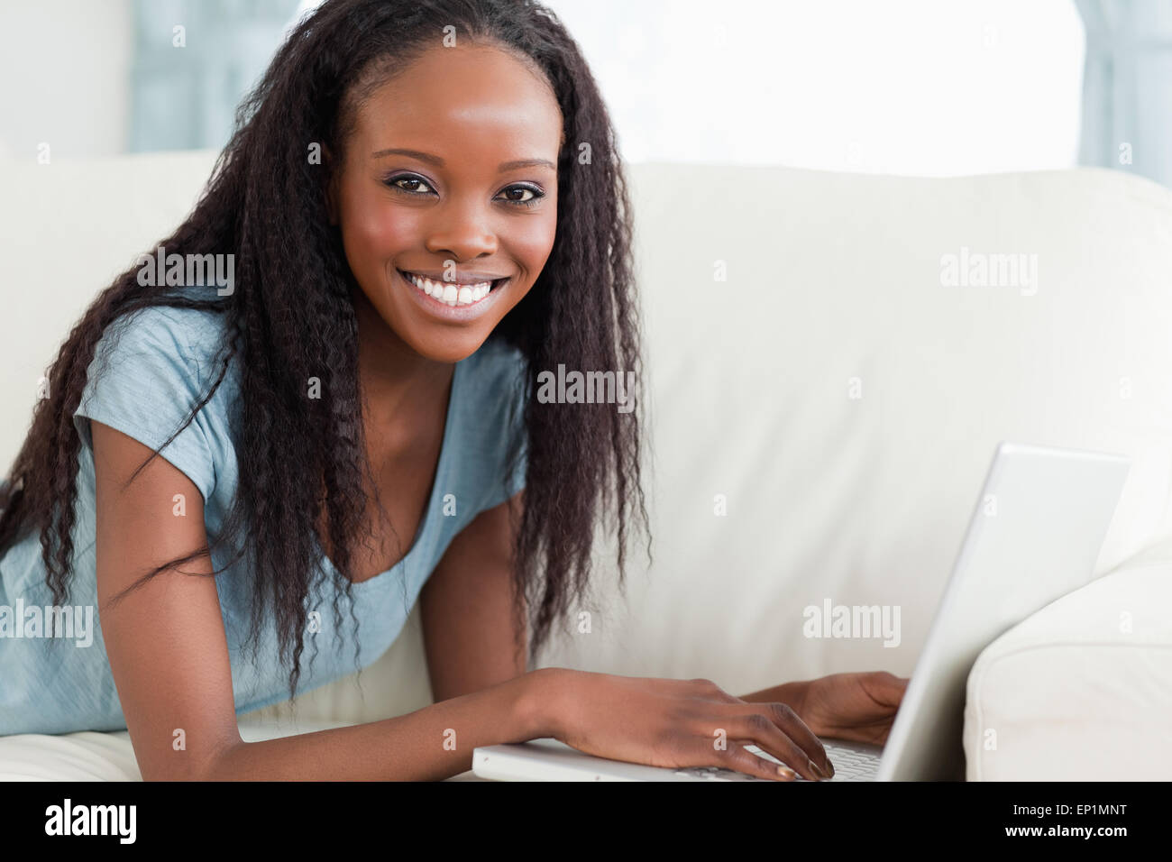 Close up of woman lying on the couch with her laptop Stock Photo - Alamy