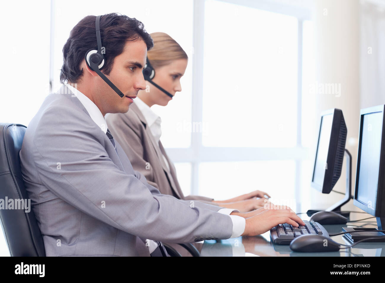 Operators using a computer Stock Photo - Alamy