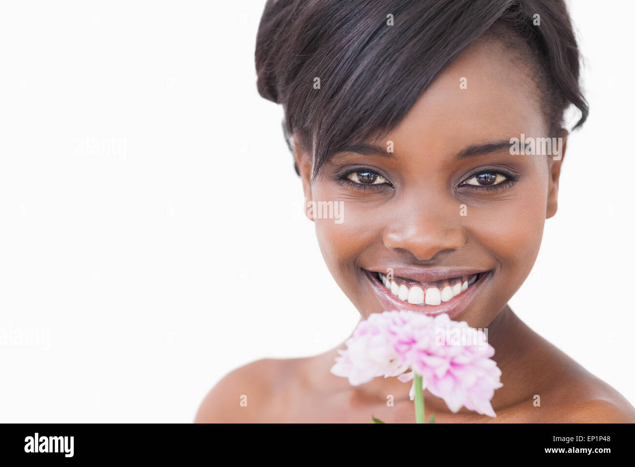 Woman smiling while holding a pink coloured flower Stock Photo - Alamy