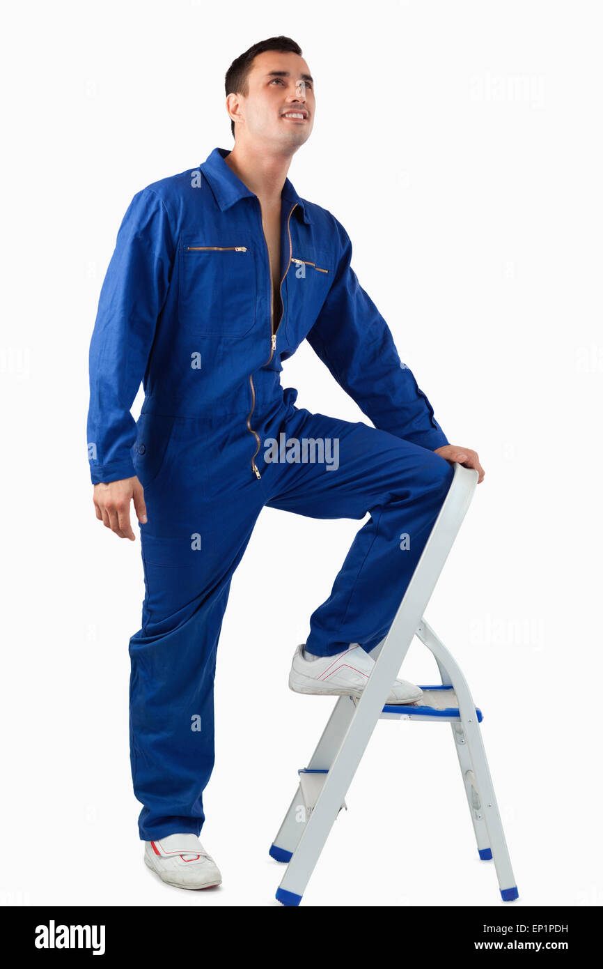 Portrait of a mechanic climbing on a stool Stock Photo - Alamy