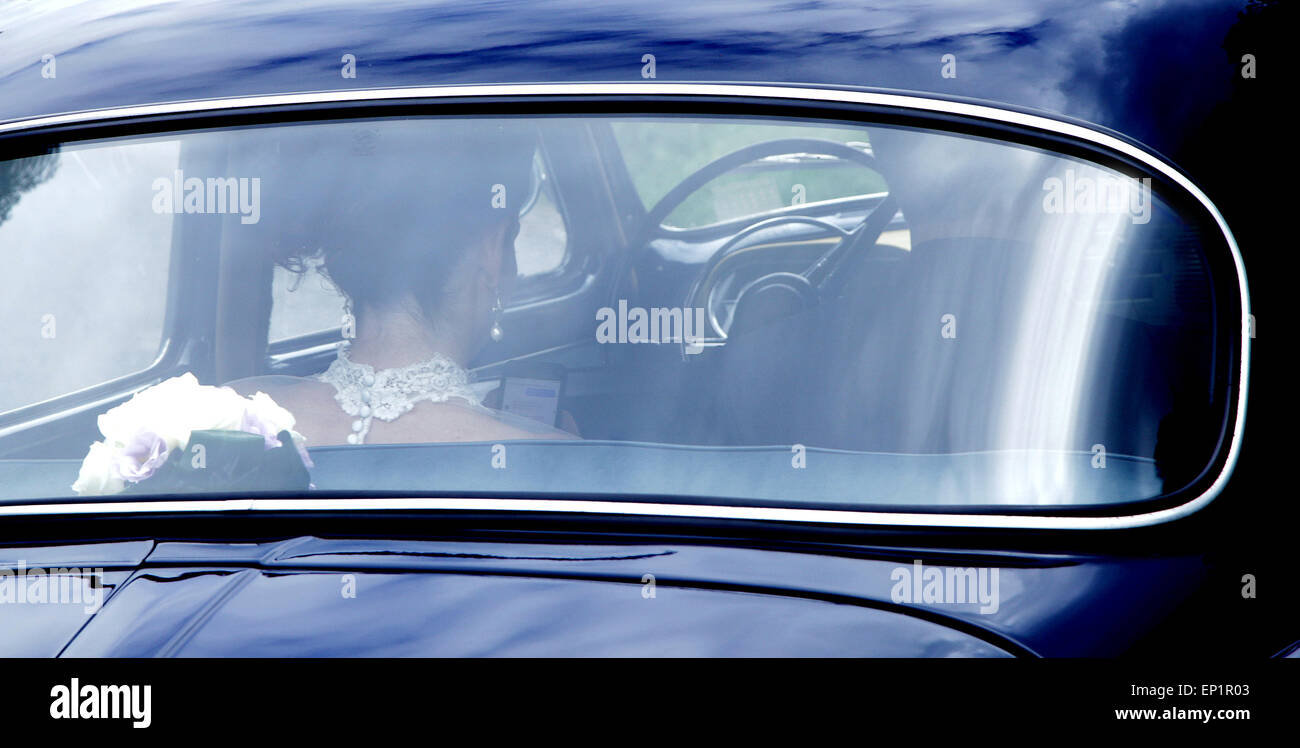 shining wedding car with bride and groom inside Stock Photo