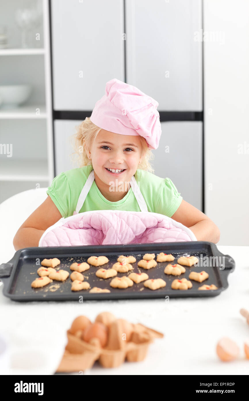 Adorable little girl shoing her cookies to the camera Stock Photo