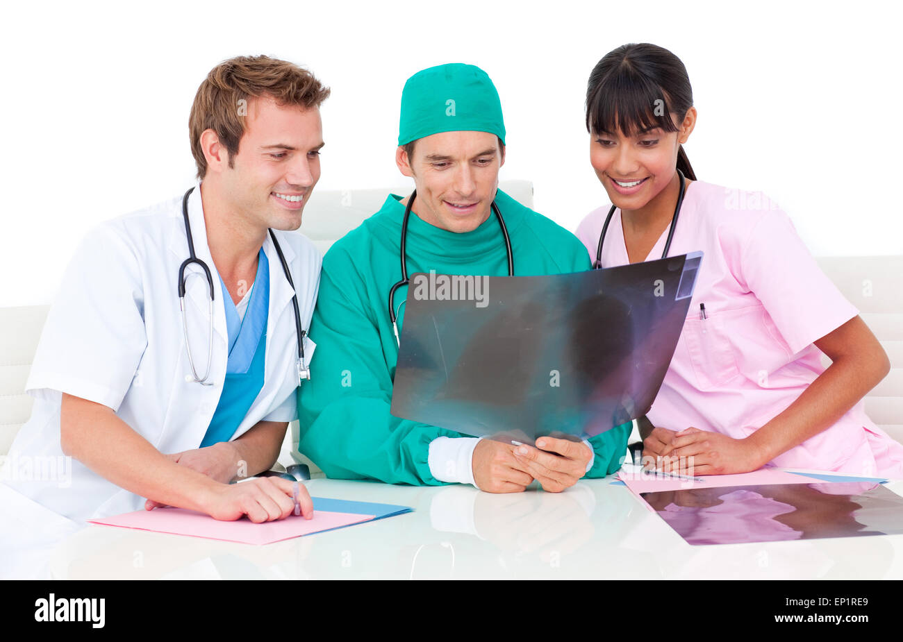Positive medical team looking at an X-ray against a white background Stock Photo