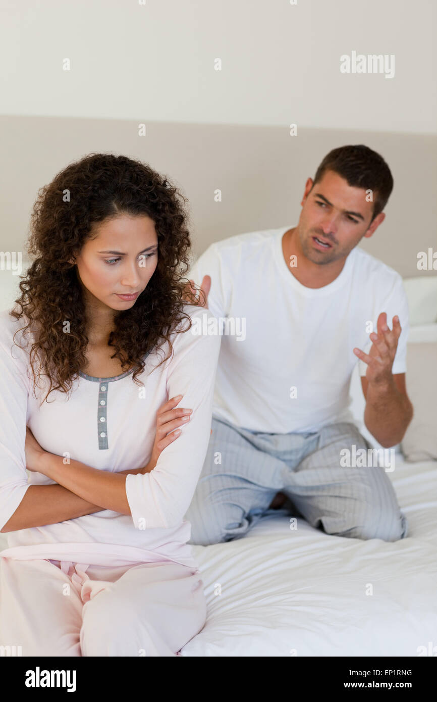 Young couple having a dispute on the bed Stock Photo - Alamy