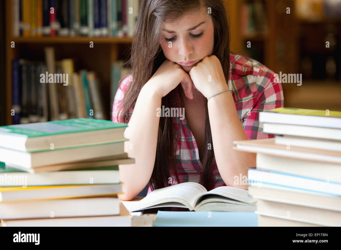 Studious woman surrounded by books Stock Photo Alamy