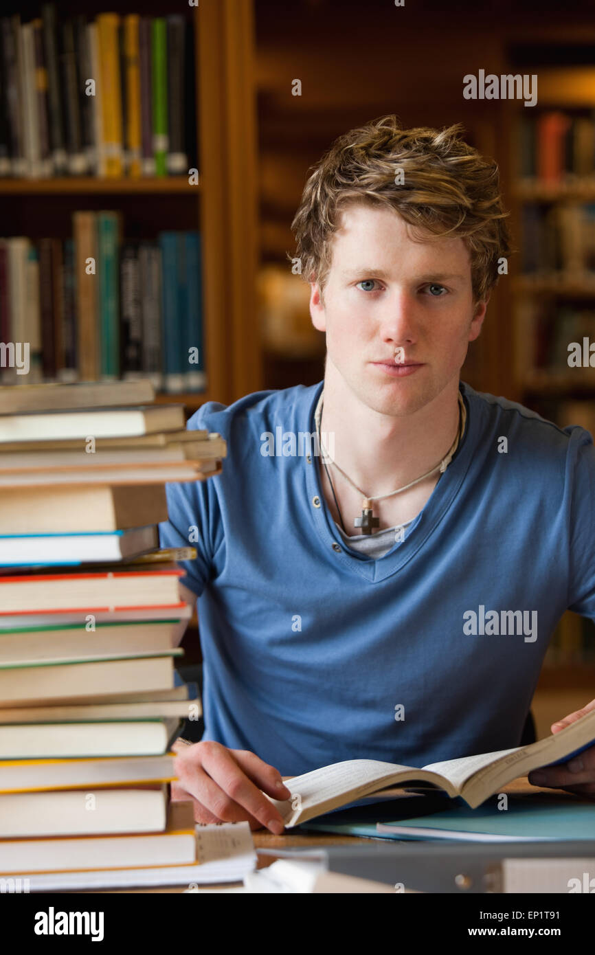 Portrait of a male student posing with books Stock Photo - Alamy
