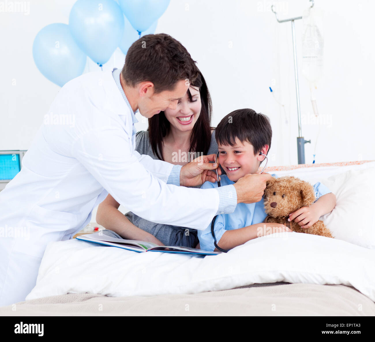 Smiling doctor playing with a little boy and his mother Stock Photo - Alamy