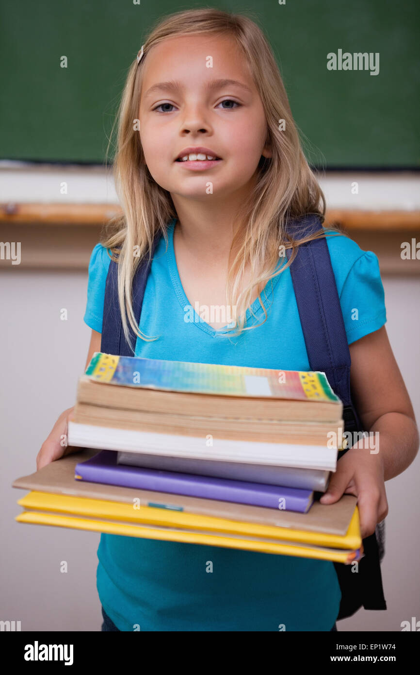 Portrait of a happy schoolgirl holding her books Stock Photo - Alamy