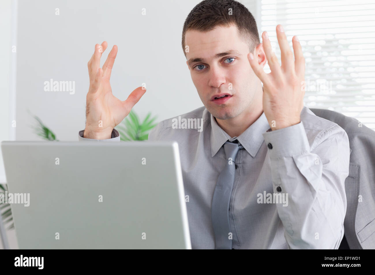 Businessman unhappy about his laptop Stock Photo - Alamy