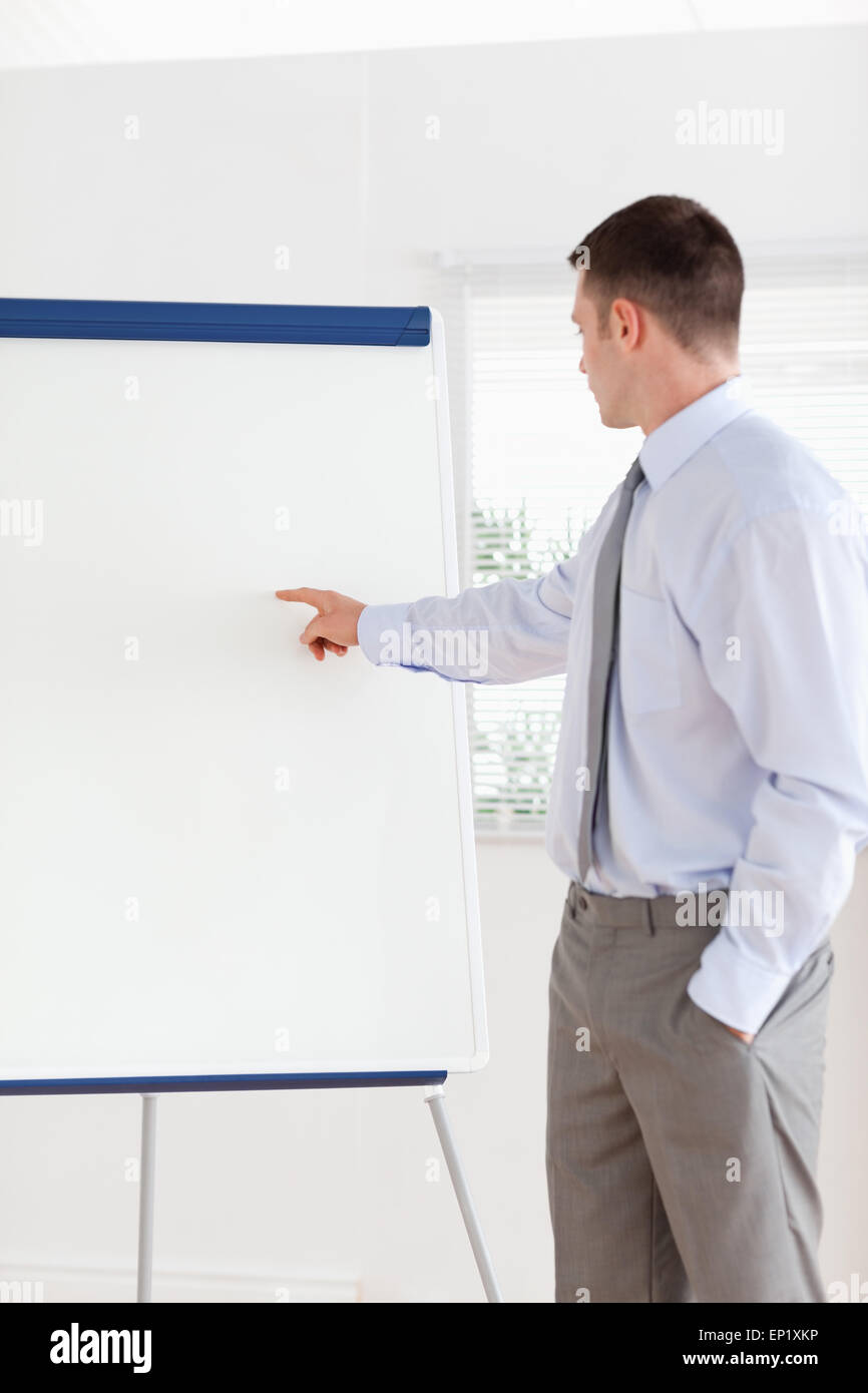 Businessman pointing at the middle of a flip chart Stock Photo