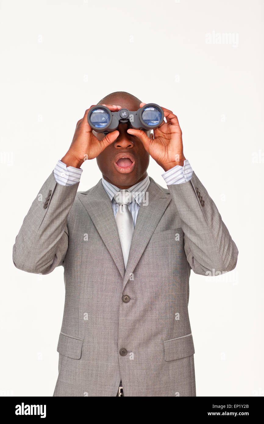 Surprised Afro-American businessman looking through binoculars Stock Photo