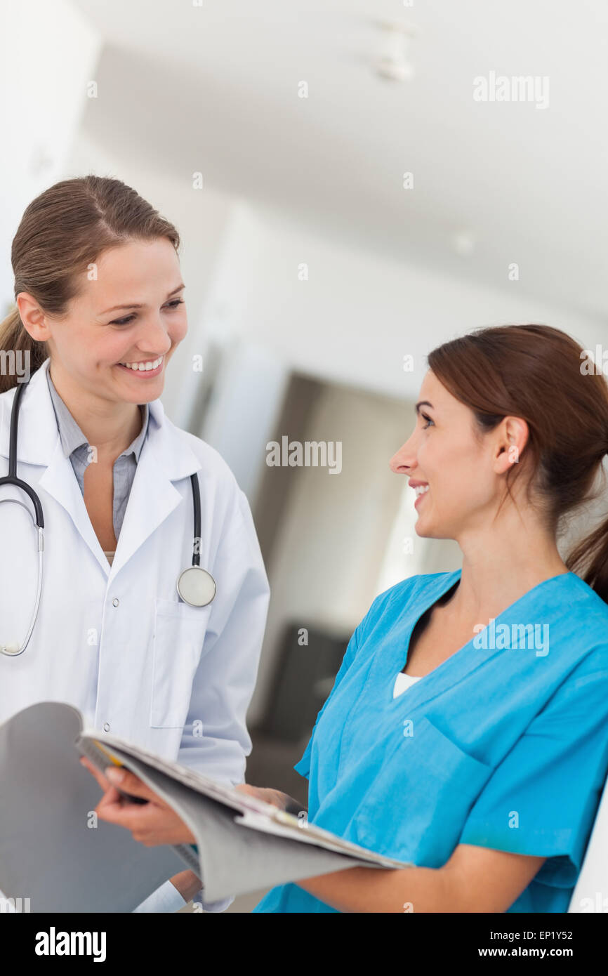 Doctor and nurse smiling while looking at each other Stock Photo