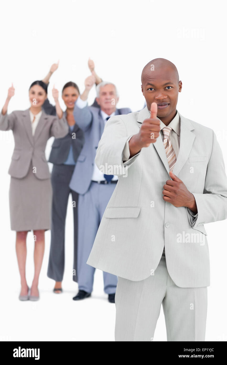 Tradesman with team behind him giving thumb up Stock Photo - Alamy
