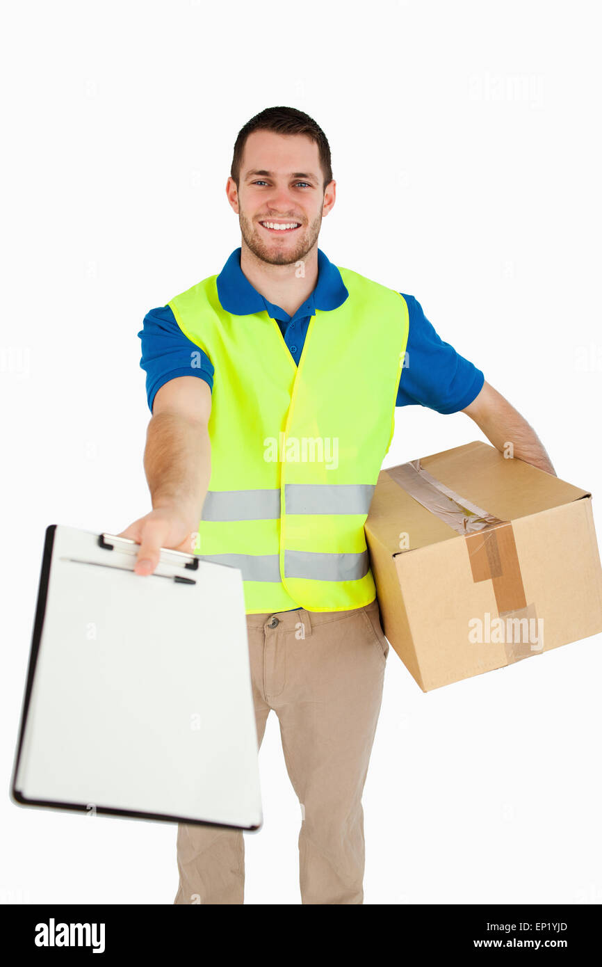 Smiling young delivery man handing hi-res stock photography and images ...