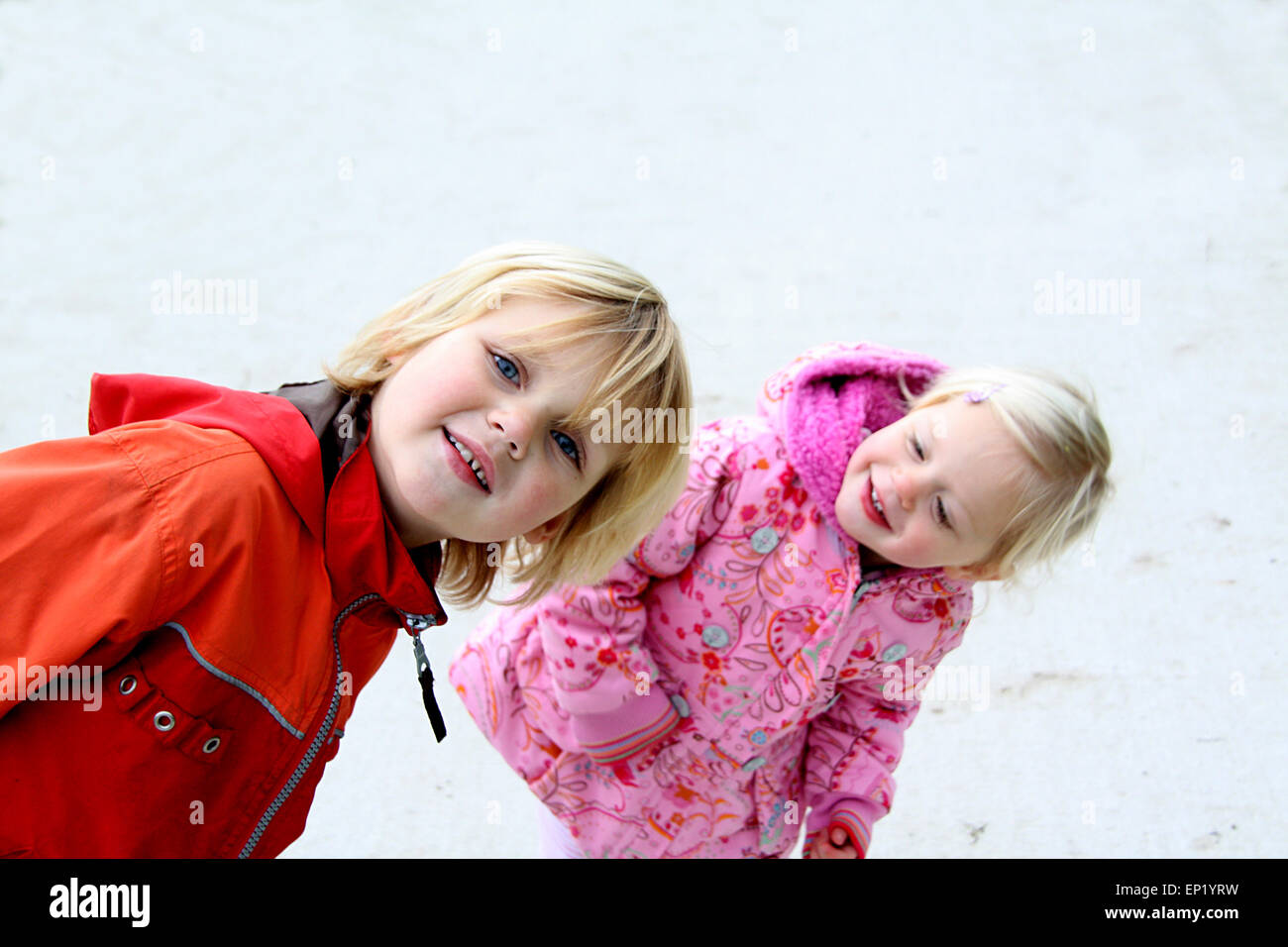Boy and girl messing about outdoors in winter Stock Photo