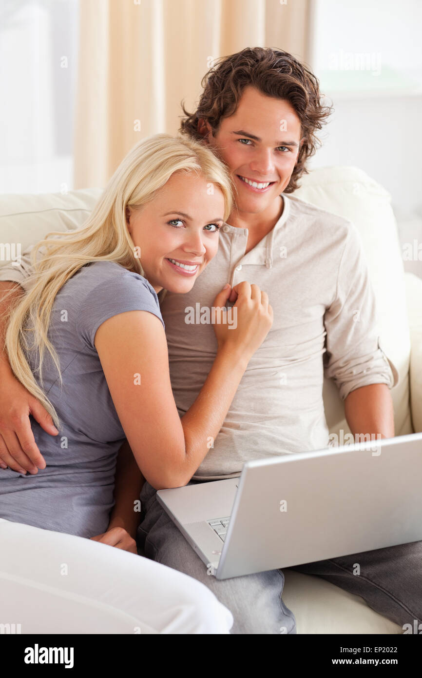 Portrait of a happy young couple using a laptop Stock Photo - Alamy
