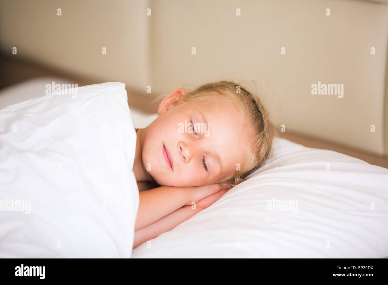 Adorable little girl sleeping in the bed Stock Photo - Alamy