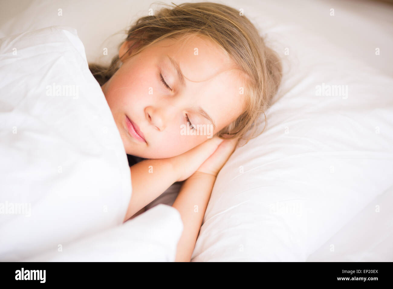Adorable little girl sleeping in the bed Stock Photo - Alamy