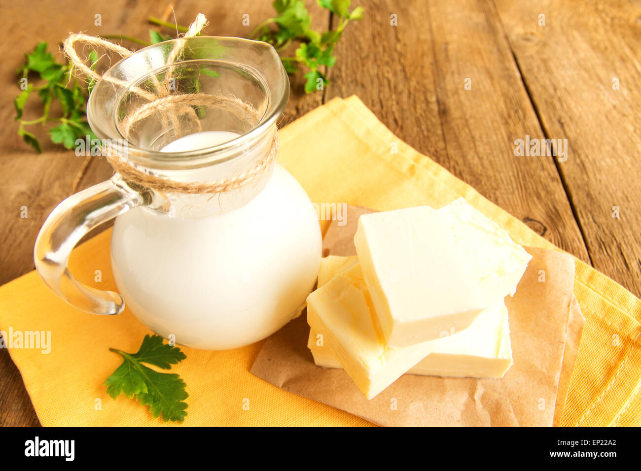 Butter and milk (dairy products) over rustic wooden table Stock Photo