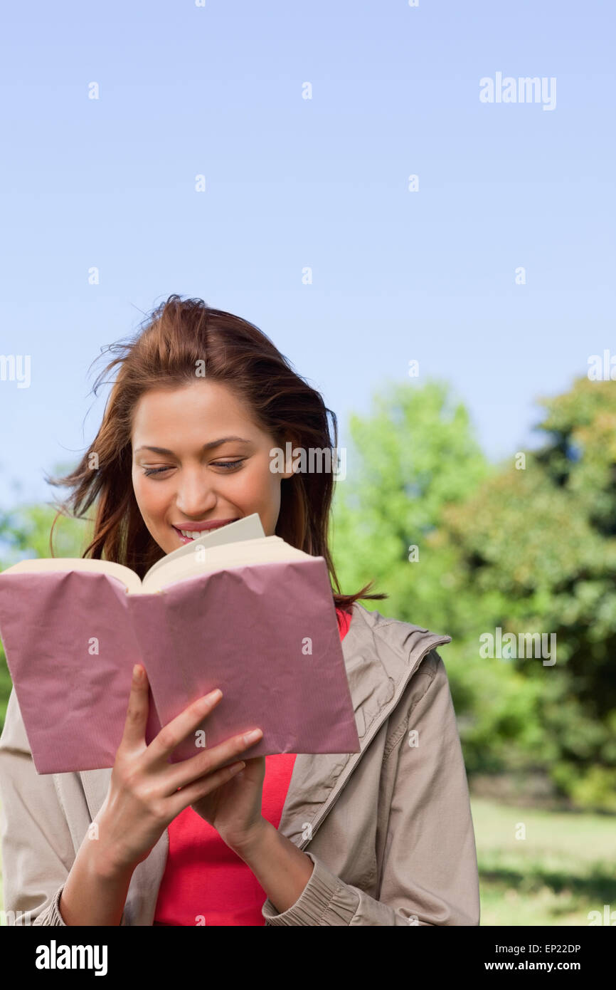 Woman happily reading a book with the wind blowing through her hair Stock Photo Alamy Woman happily reading a book with the wind blowing through her hair Stock Photo Alamy