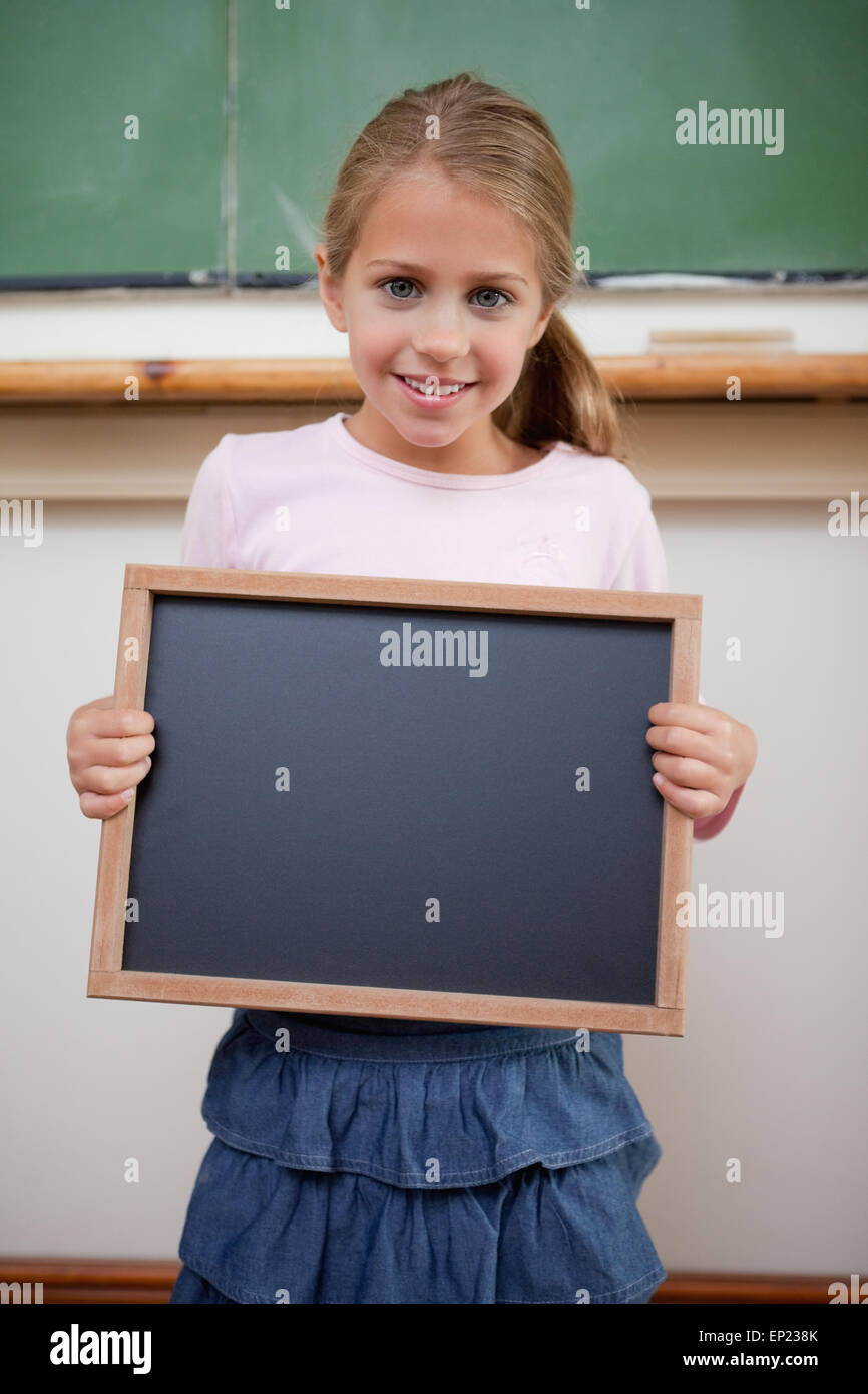 Portrait of a young girl holding at a school slate Stock Photo - Alamy